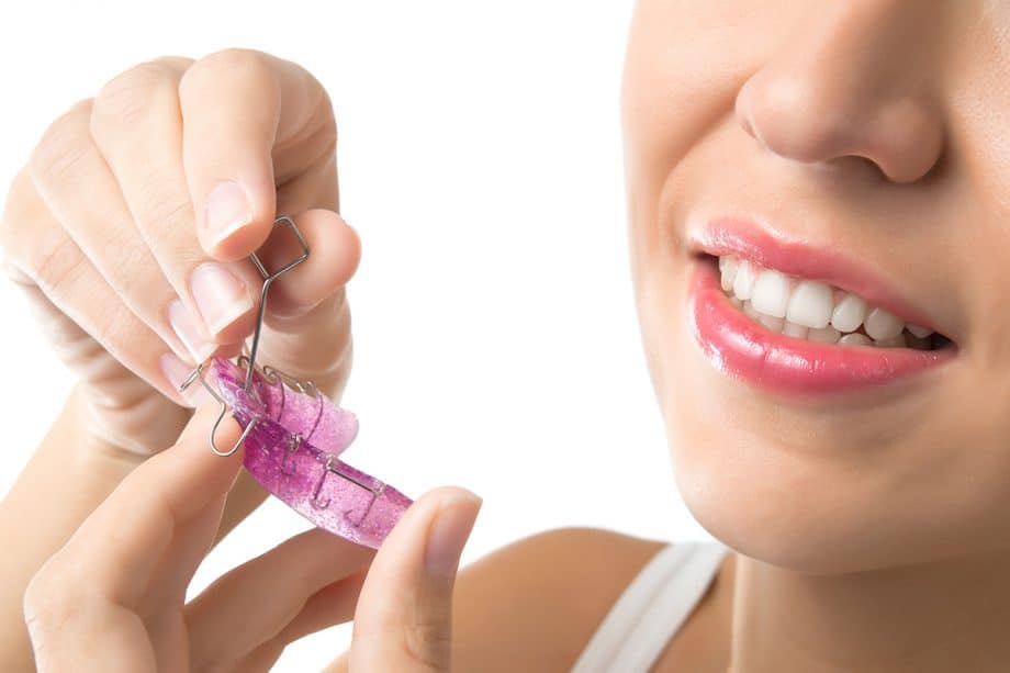 a person cleans a retainer