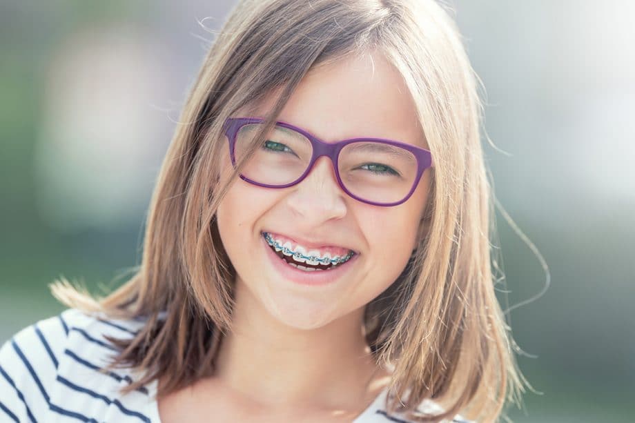 young girl with braces laughing